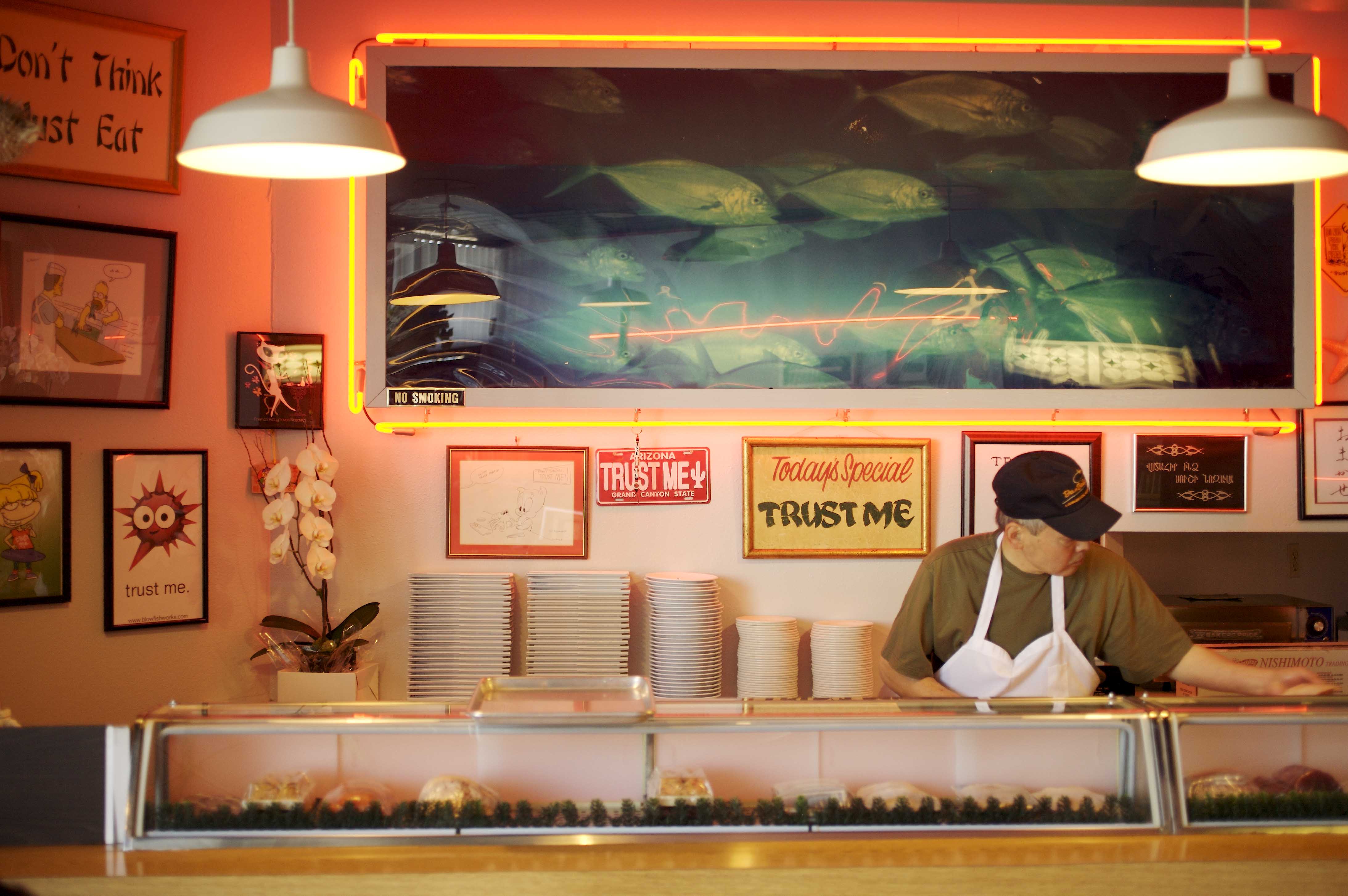 Chef Nozawa standing behind sushi bar at original Sushi Nozawa in Studio City